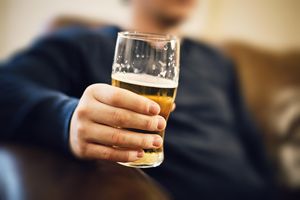 man holding glass of beer