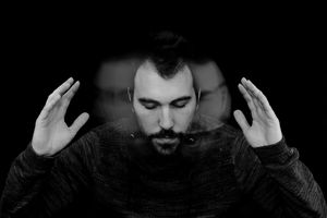 Digitally Generated Image Of Man Shaking Head Against Black Background