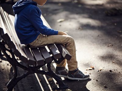 Sad boy sitting on bench