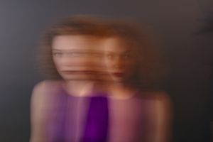 Portrait of red-haired woman, blurred, double