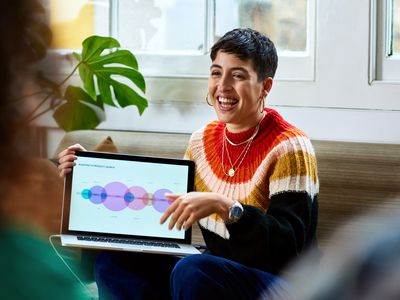 Cheerful young woman with laptop smiling