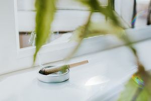 Smoking Spliff on a Clean White Surface against an Open Window