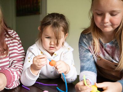 Siblings at table doing crafts