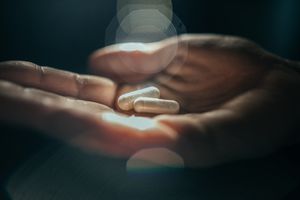 person holding pills in their hand