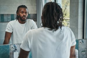 man staring at himself in the mirror