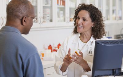 Pharmacist talking to customer about prescription