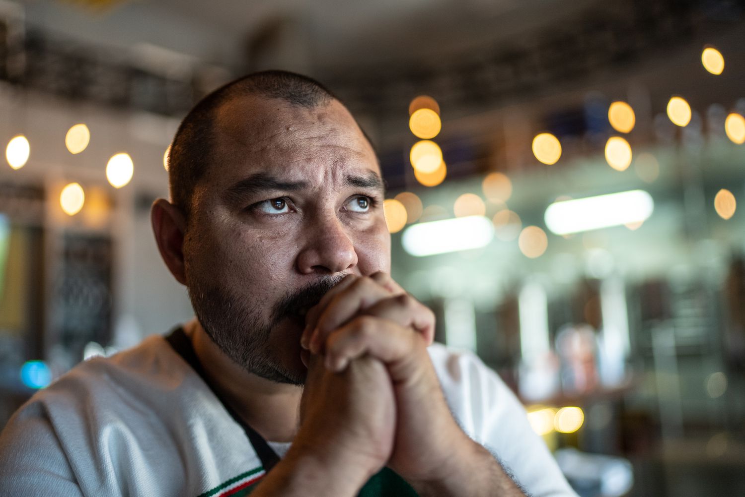Mid adult man watching a soccer game at bar