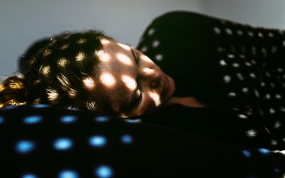 Depressed woman lying on the bed at home.