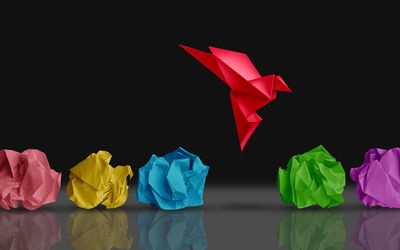 origami bird in flight standing out