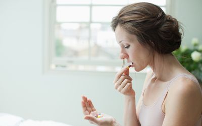 woman taking medication