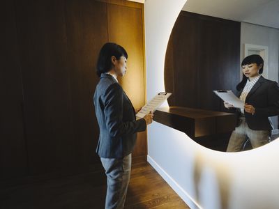 One woman, rehearsing a speech in mirror at home