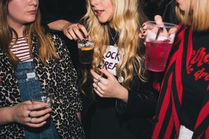 young women drinking together