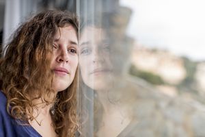 Sad woman looking out window