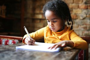 Girl writing on paper