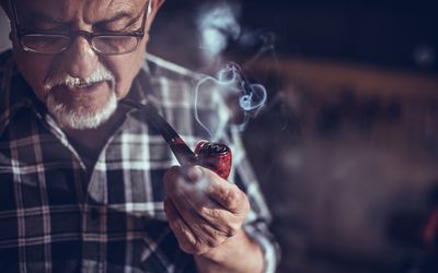 Old man smoking with pipe