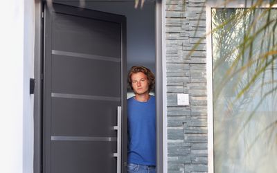Man opening the door of his home