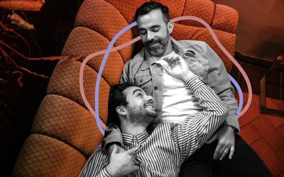 two men holding each other and smiling